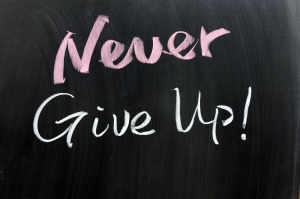 Never give up words written on the chalkboard